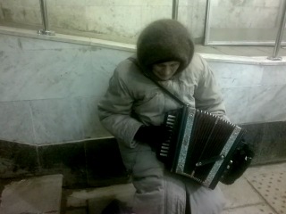 this is how a grandmother gets bread in the kazan metro, playing on the tatar national harmonica